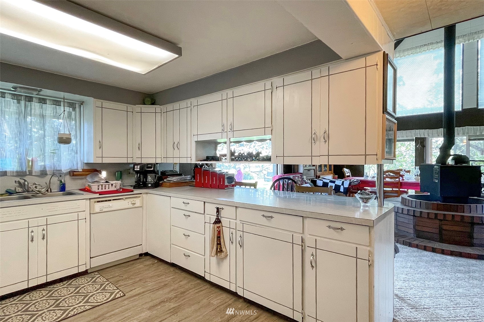 371 Lake Farm Road Port Angeles, WA 98362 - Photo 9 of 36 a kitchen with kitchen island granite countertop a sink cabinets and stainless steel appliances