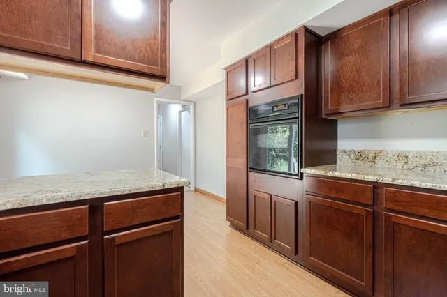 a kitchen with granite countertop stainless steel appliances and wooden cabinets