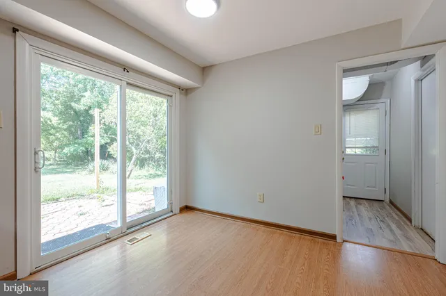 a view of a room with wooden floor and walls
