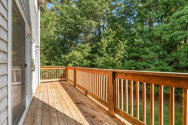 a balcony with wooden floor and fence
