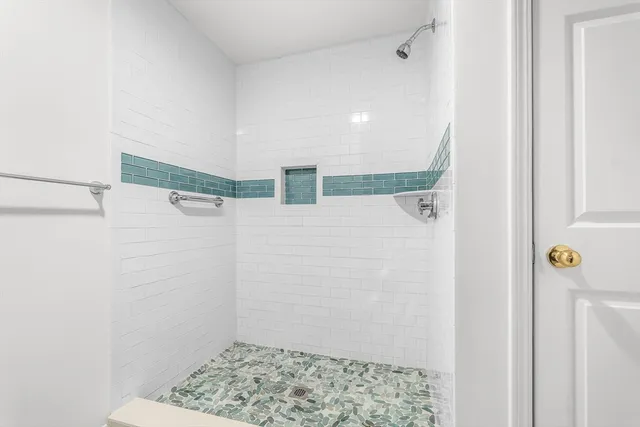 a bathroom with a shower and a shower