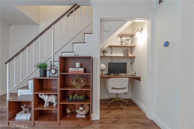 a view of workspace with wooden floor and furniture