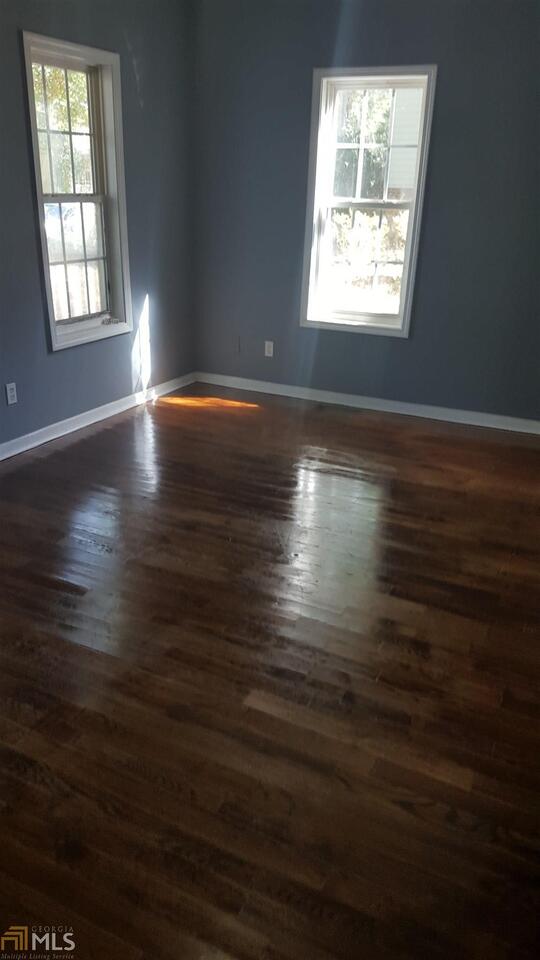 854 Ridge Avenue Northwest, Unit A Atlanta, GA 30318 - Photo 4 of 9 an empty room with wooden floor and windows