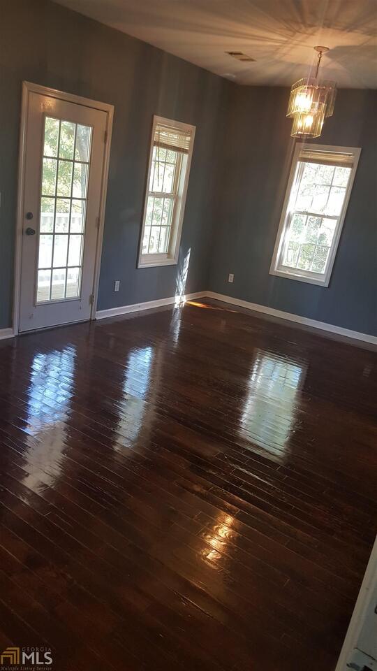 854 Ridge Avenue Northwest, Unit A Atlanta, GA 30318 - Photo 5 of 9 a view of an empty room with wooden floor and a window