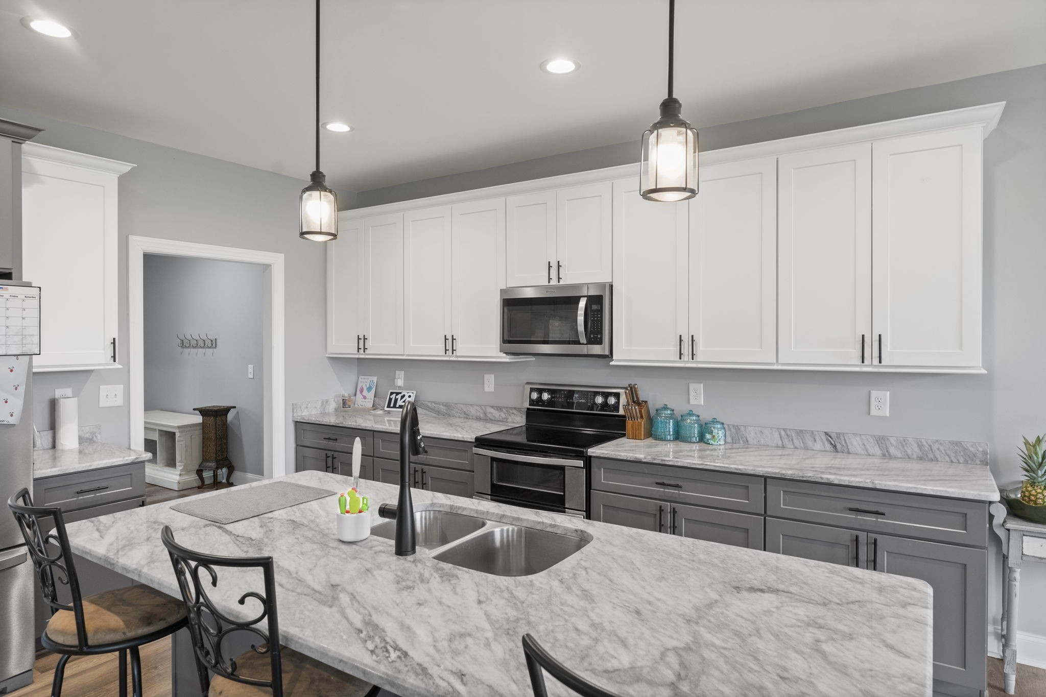 147 Roberts Road Portland, TN 37148 - Photo 11 of 30 a kitchen with stainless steel appliances granite countertop a stove a sink a microwave a refrigerator a dining table and chairs with wooden floor