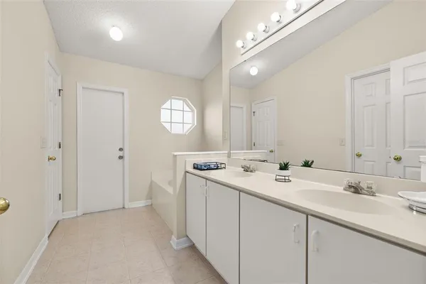 a spacious bathroom with a double vanity sink and a mirror