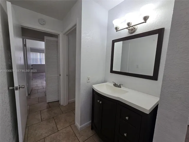 a bathroom with a sink vanity and a mirror