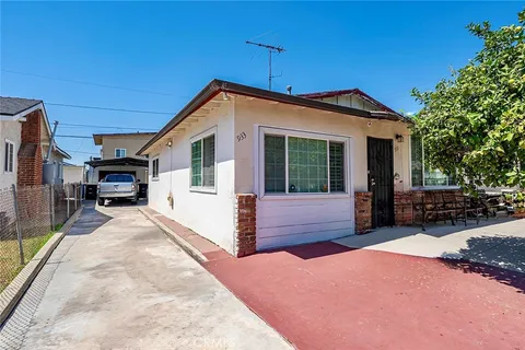 a front view of a house with a yard and seating space