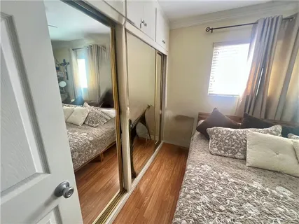a bedroom with a bed and a couch