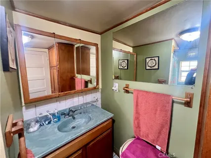 a bathroom with a sink mirror vanity and toilet