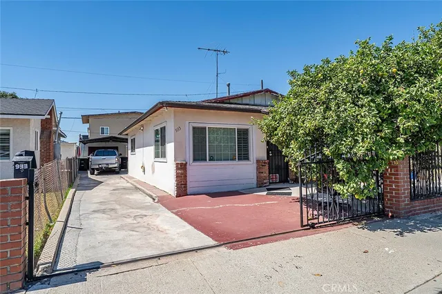 a front view of a house with glass doors and outdoor space