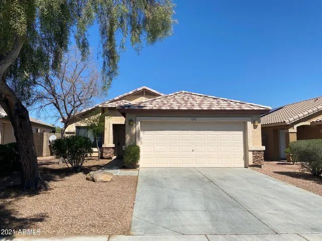 a view of a house with a yard and garage