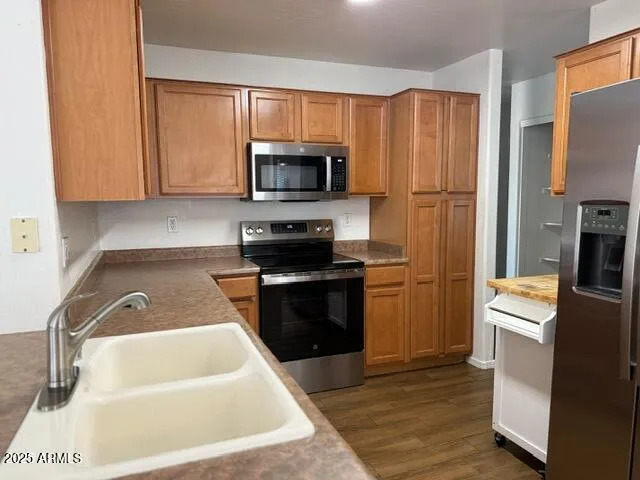 a kitchen with a sink a stove and refrigerator