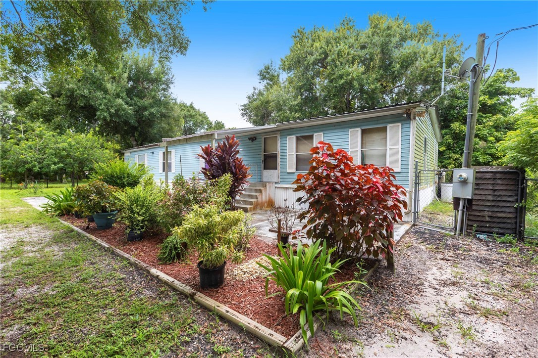 3180 Packinghouse Road Alva, FL 33920 - Photo 2 of 9 a view of house with tall trees