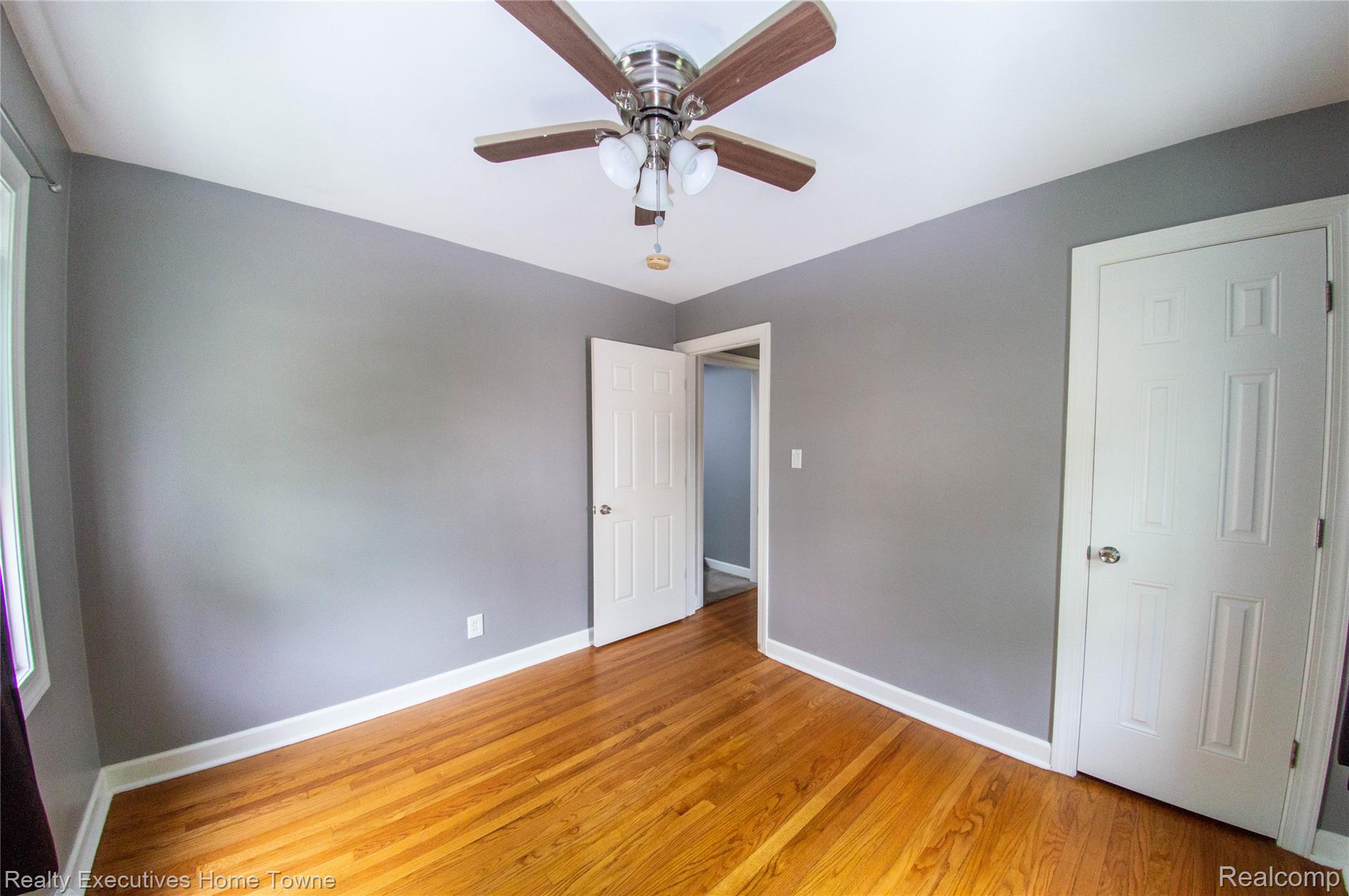 2676 Cumberland Road Berkley, MI 48072 - Photo 14 of 38 Hardwood flooring throughout this room, featuring a ceiling fan with integrated lighting