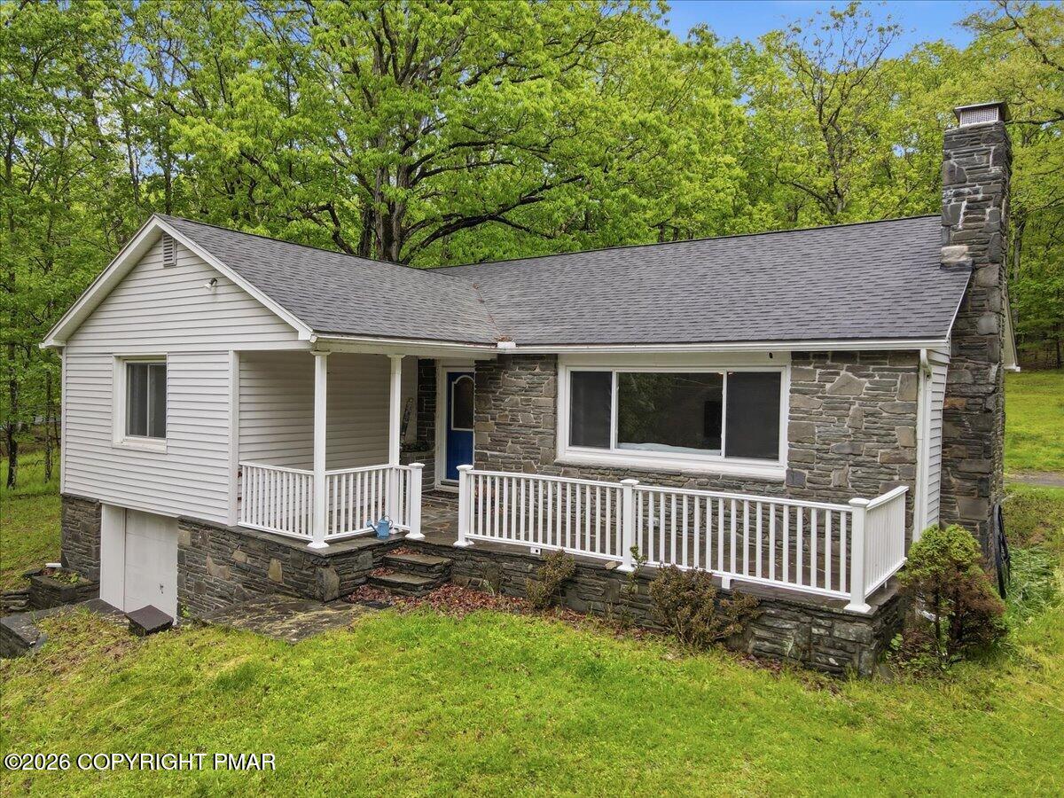232 Garrity Road Hawley, PA 18428 - Photo 1 of 57 a front view of a house with a yard