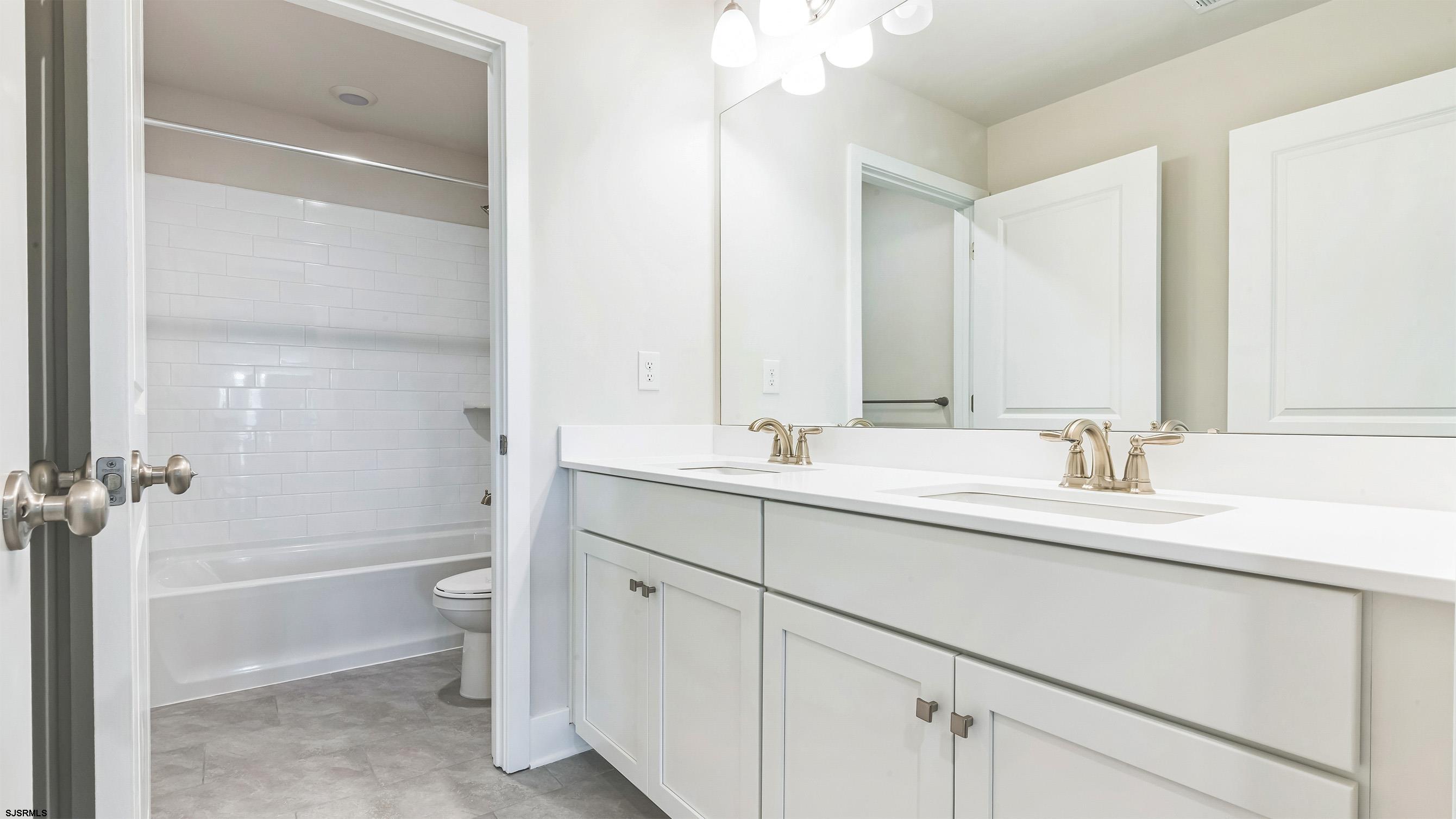 12 Henry Road Marmora, NJ 08223 - Photo 13 of 16 a bathroom with a sink a toilet and a large mirror