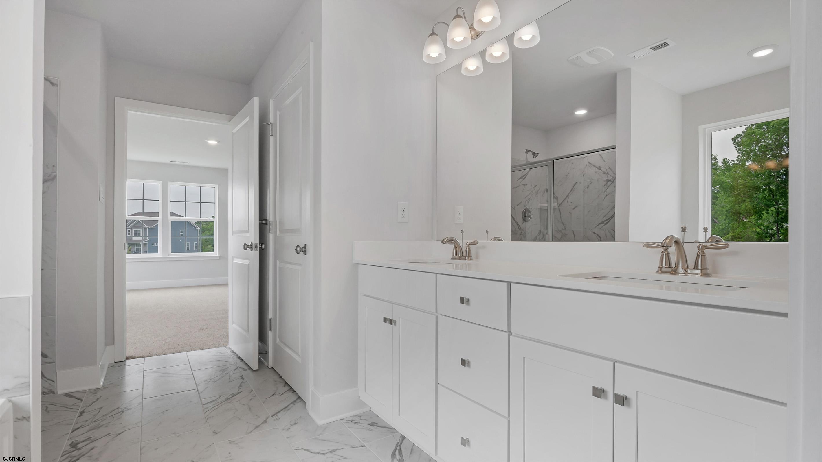 12 Henry Road Marmora, NJ 08223 - Photo 14 of 16 a bathroom with double vanity sink and a mirror