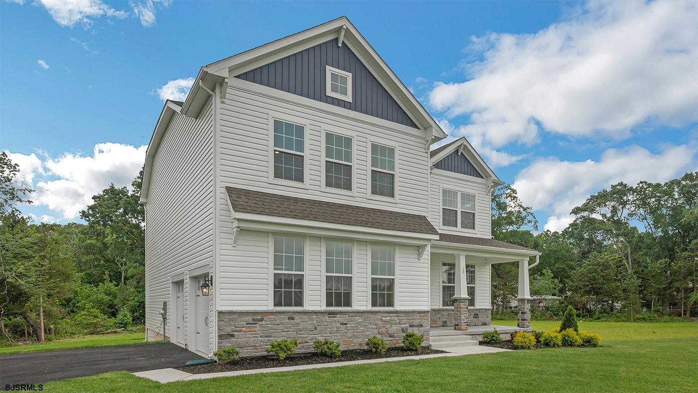 12 Henry Road Marmora, NJ 08223 - Photo 2 of 16 a front view of a house with a yard