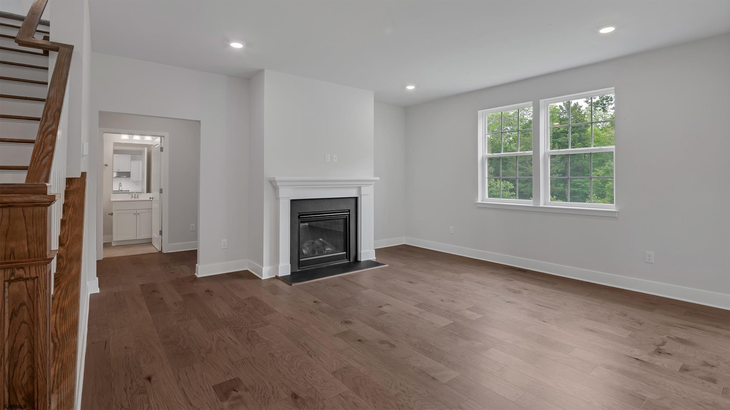 12 Henry Road Marmora, NJ 08223 - Photo 6 of 16 an empty room with windows and fireplace