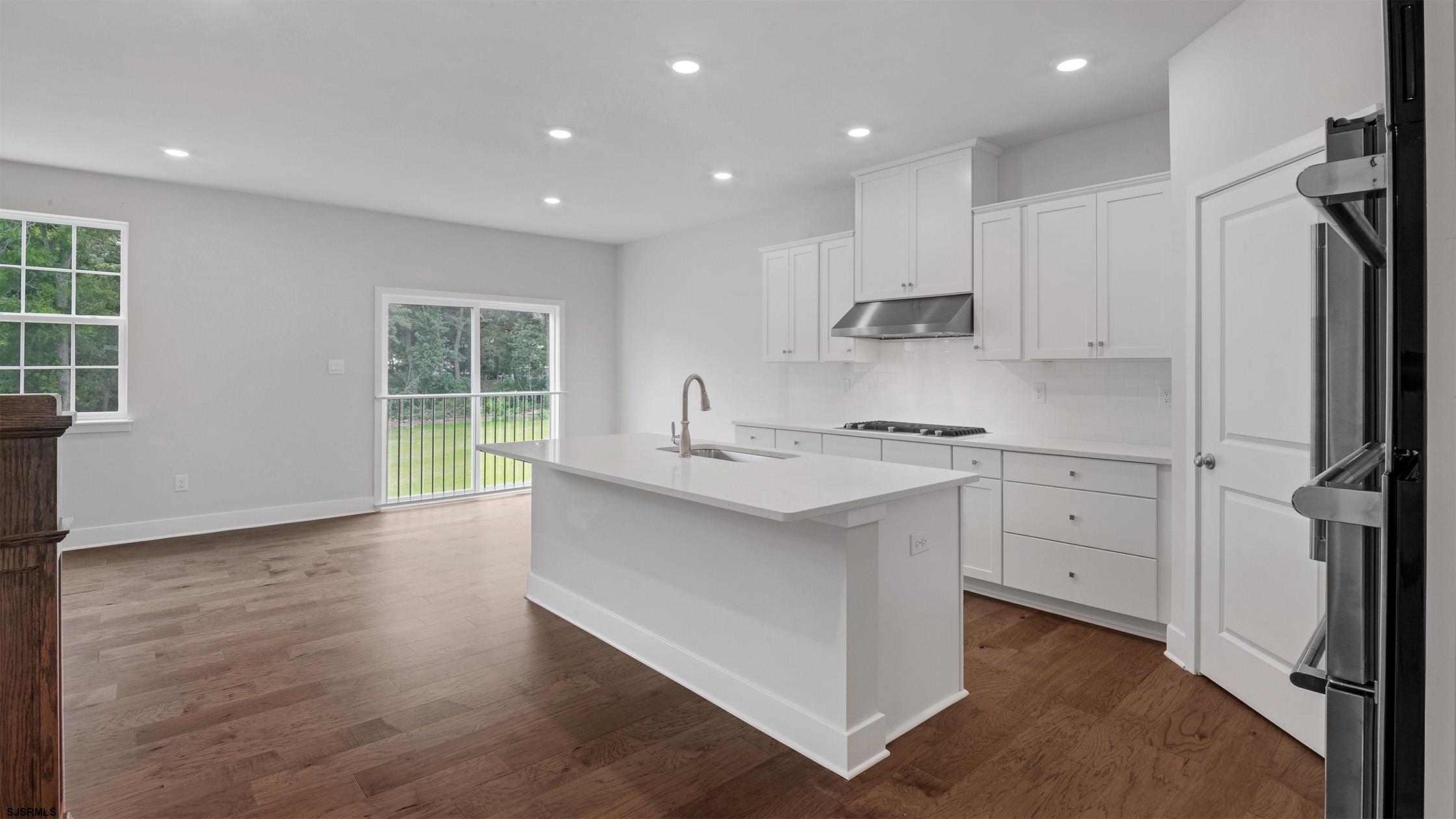 12 Henry Road Marmora, NJ 08223 - Photo 7 of 16 a kitchen with white cabinets and sink
