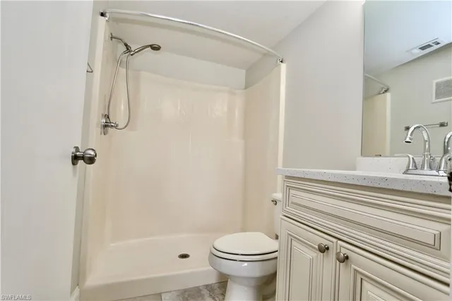 a bathroom with a shower a toilet and a sink