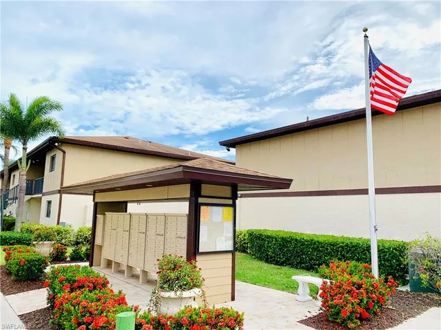 a front view of a house with a yard and outdoor seating