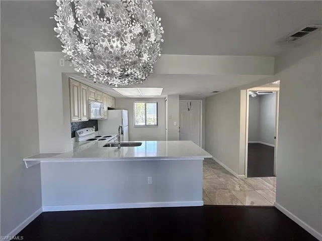 a view of living room with furniture and a chandelier