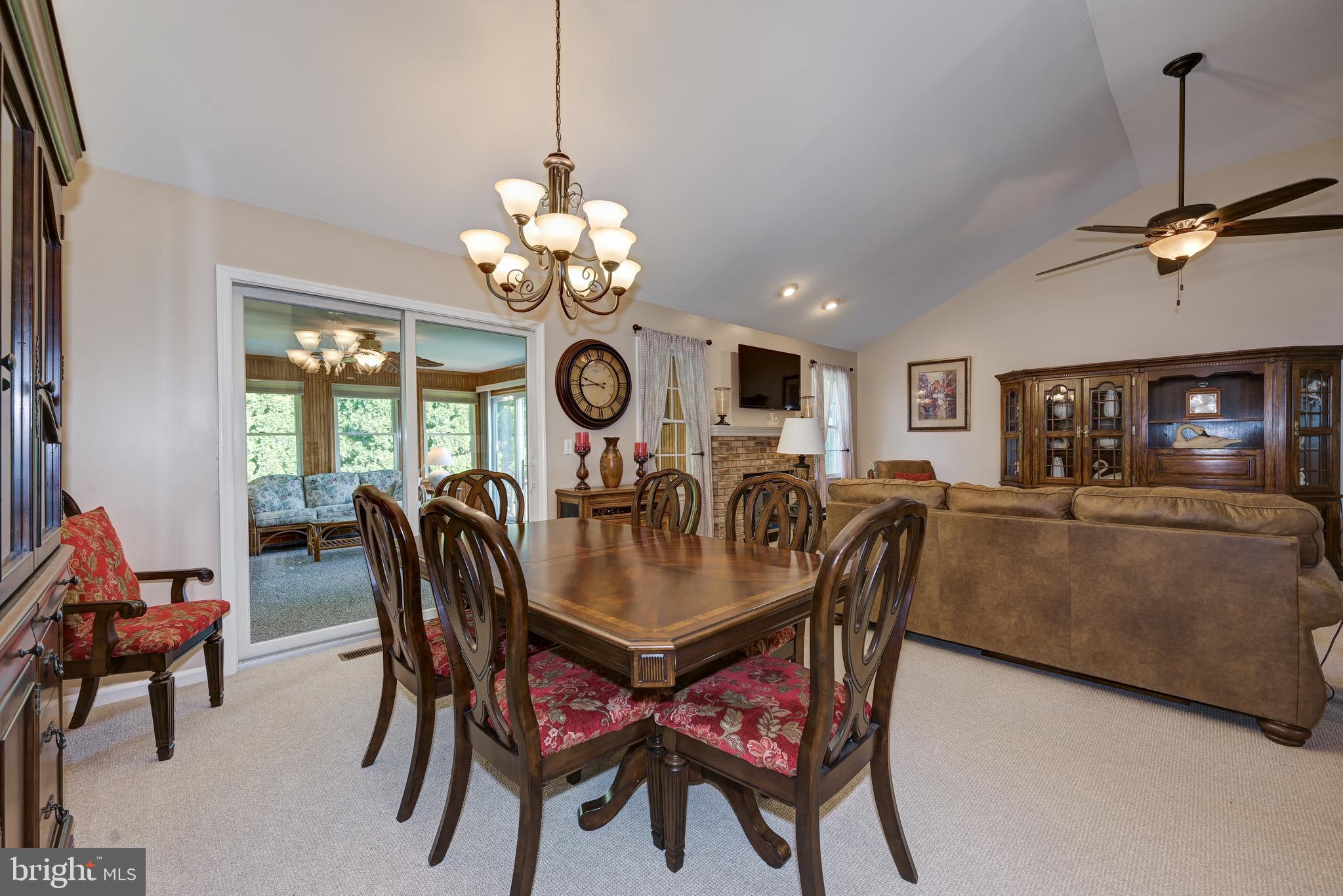 137 Skipper Road Manahawkin, NJ 08050 - Photo 11 of 33 a dining room with furniture a chandelier and window