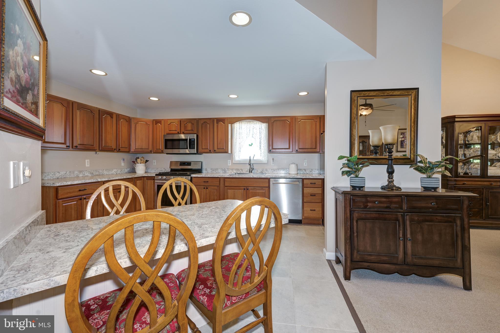 137 Skipper Road Manahawkin, NJ 08050 - Photo 13 of 33 a kitchen with stainless steel appliances granite countertop a stove top oven a sink a refrigerator and a microwave