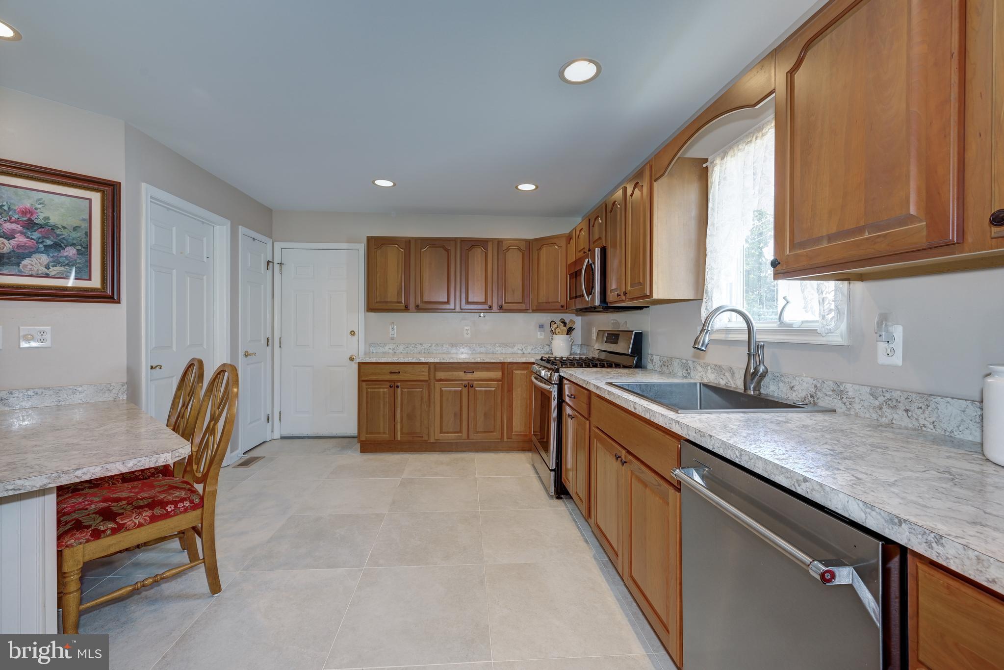 137 Skipper Road Manahawkin, NJ 08050 - Photo 16 of 33 a kitchen with a sink cabinets and window