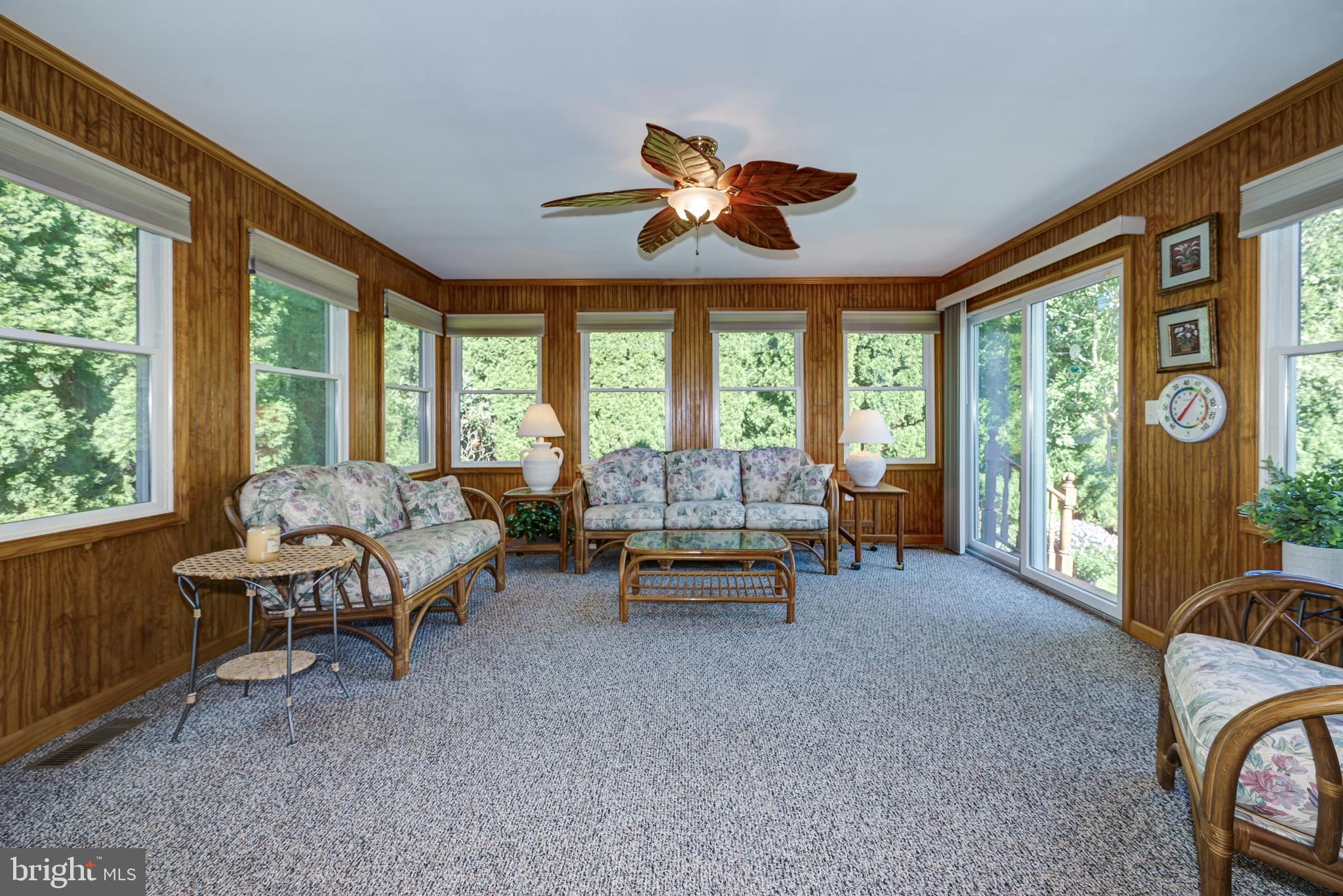 137 Skipper Road Manahawkin, NJ 08050 - Photo 18 of 33 a living room with furniture and a floor to ceiling window