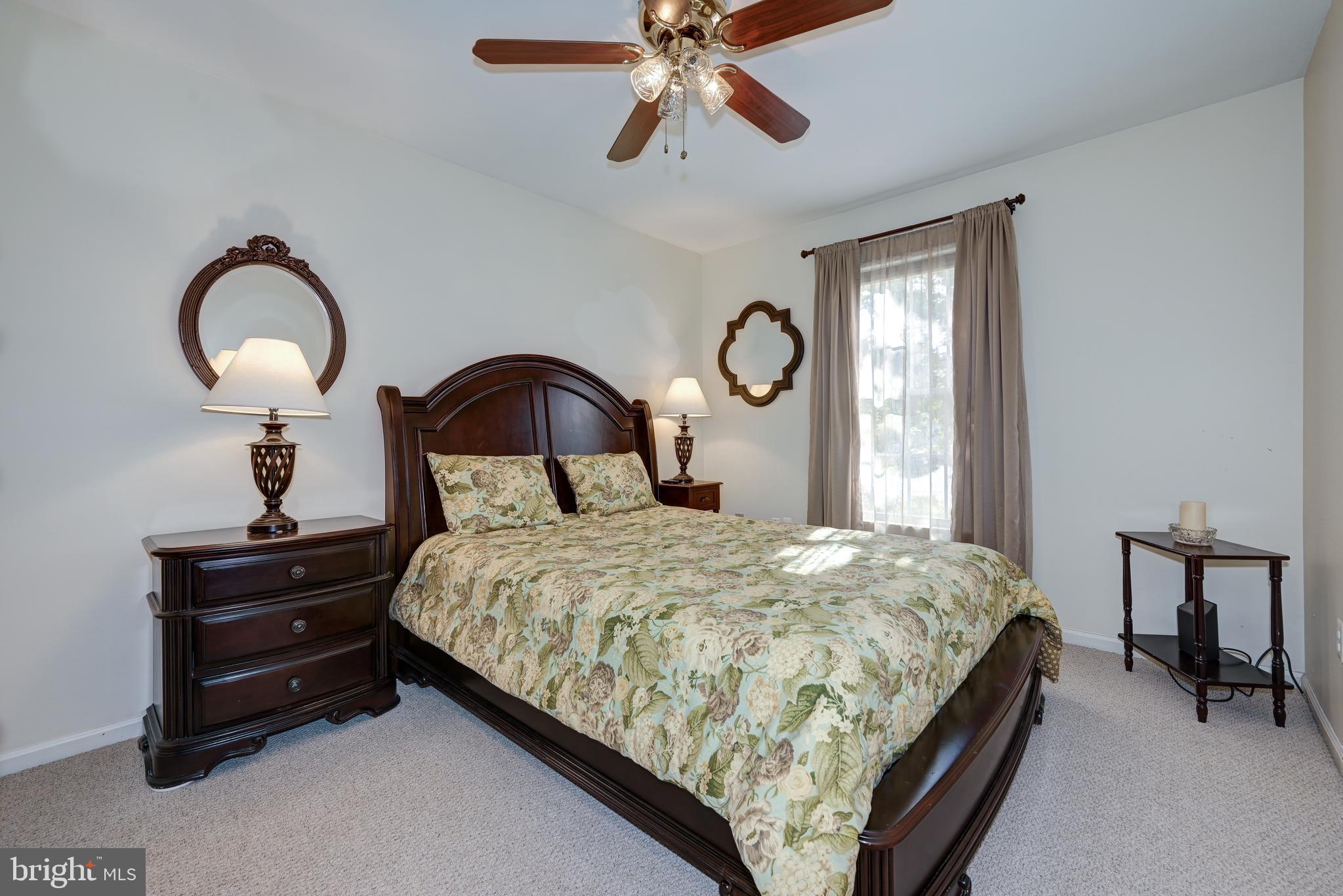 137 Skipper Road Manahawkin, NJ 08050 - Photo 20 of 33 a bedroom with a bed and a chandelier