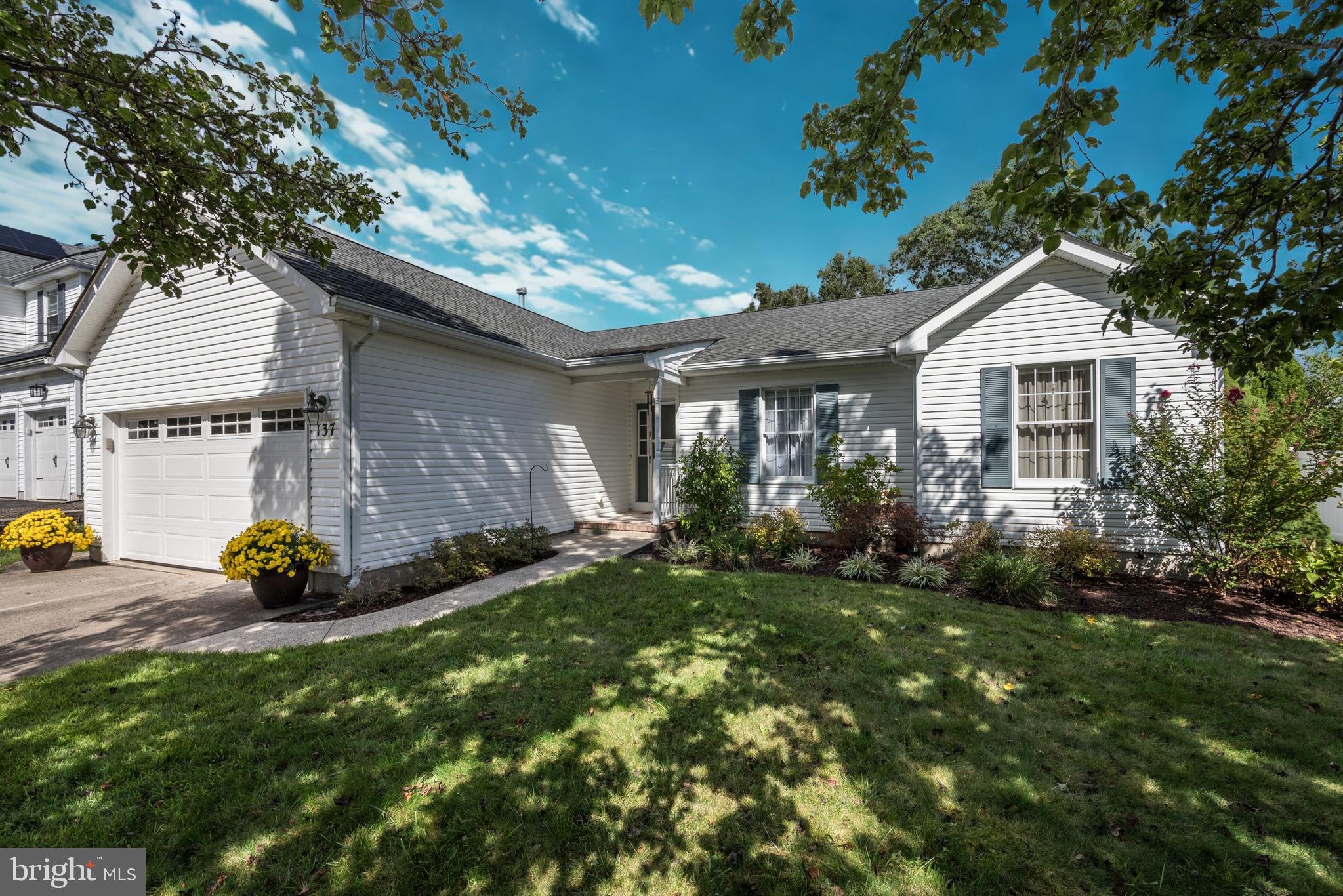 137 Skipper Road Manahawkin, NJ 08050 - Photo 2 of 33 a front view of a house with a garden
