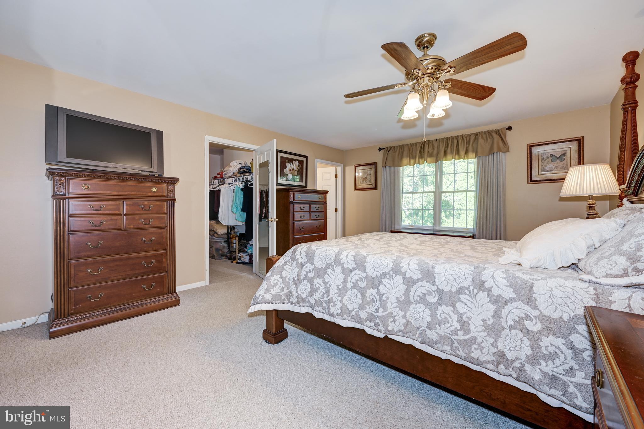 137 Skipper Road Manahawkin, NJ 08050 - Photo 22 of 33 a bedroom with a bed and a chandelier
