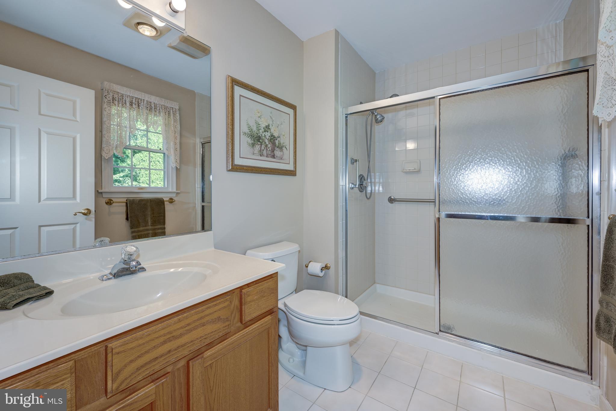137 Skipper Road Manahawkin, NJ 08050 - Photo 24 of 33 a bathroom with a sink a toilet and shower