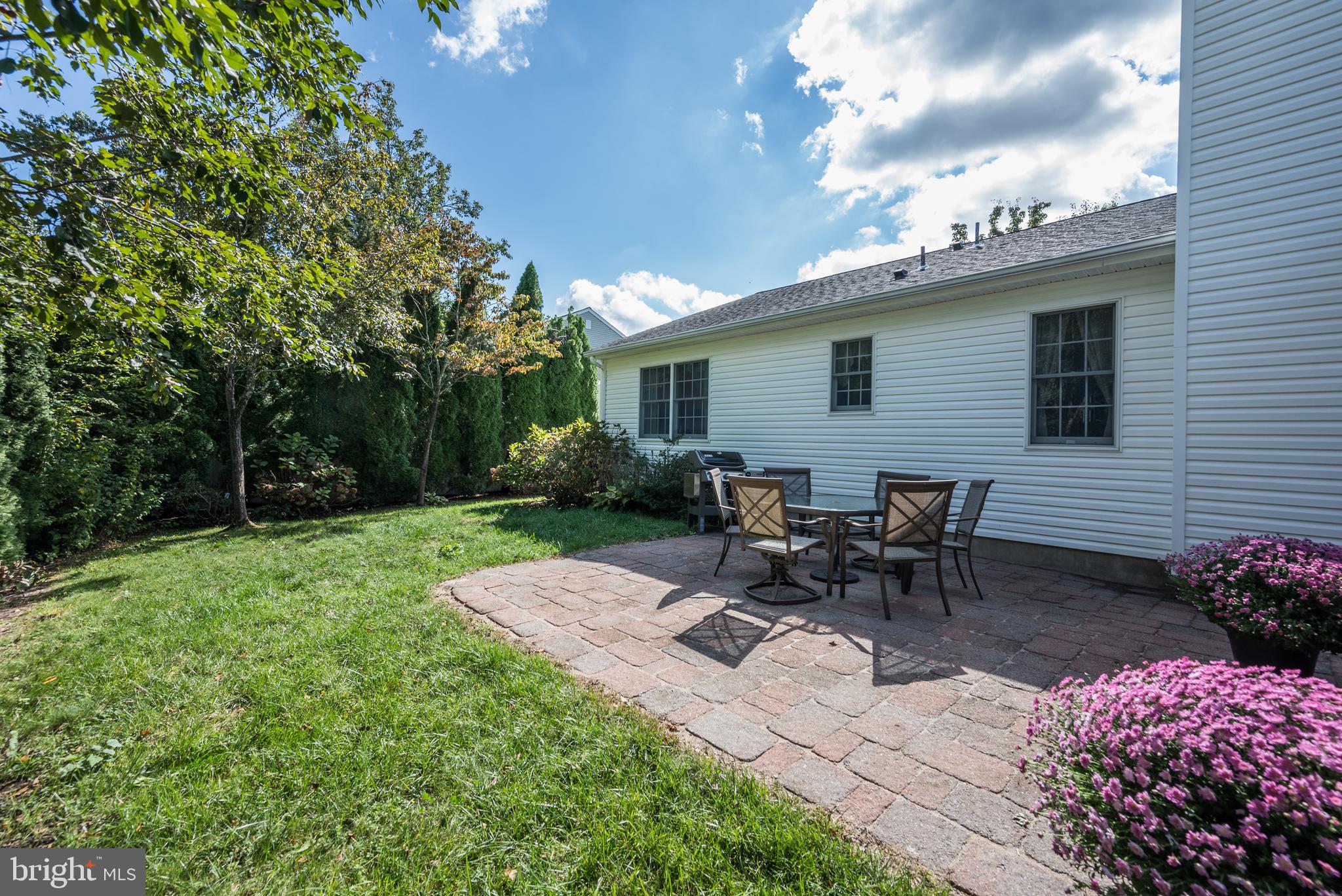 137 Skipper Road Manahawkin, NJ 08050 - Photo 30 of 33 a view of backyard with table and chairs and potted plants