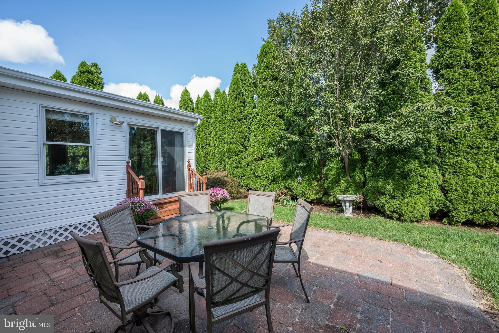 137 Skipper Road Manahawkin, NJ 08050 - Photo 31 of 33 a view of a patio with table and chairs and potted plants