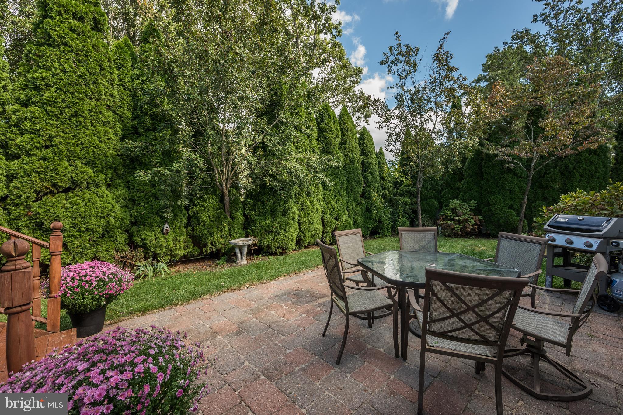 137 Skipper Road Manahawkin, NJ 08050 - Photo 32 of 33 a view of a chairs and table in backyard of the house