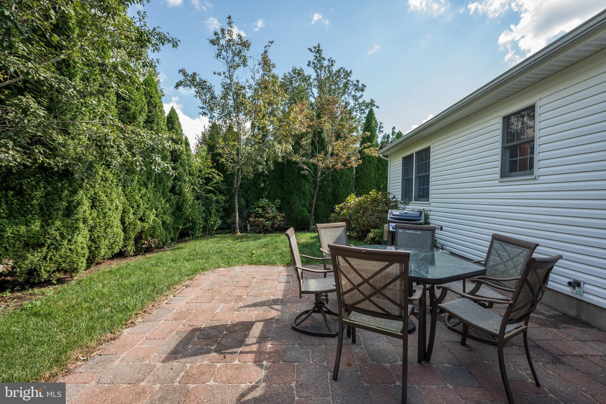 137 Skipper Road Manahawkin, NJ 08050 - Photo 33 of 33 a view of a chairs and table in backyard of the house