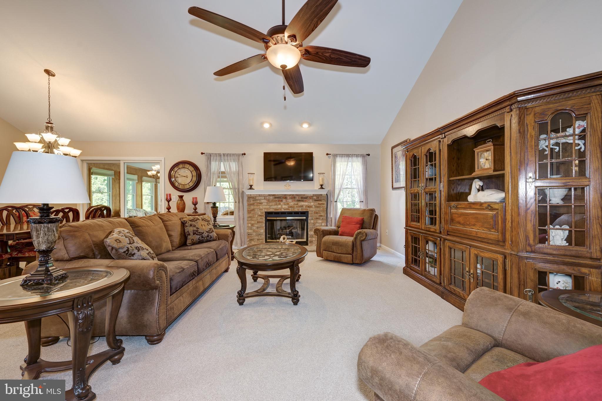 137 Skipper Road Manahawkin, NJ 08050 - Photo 5 of 33 a living room with furniture ceiling fan and a fireplace