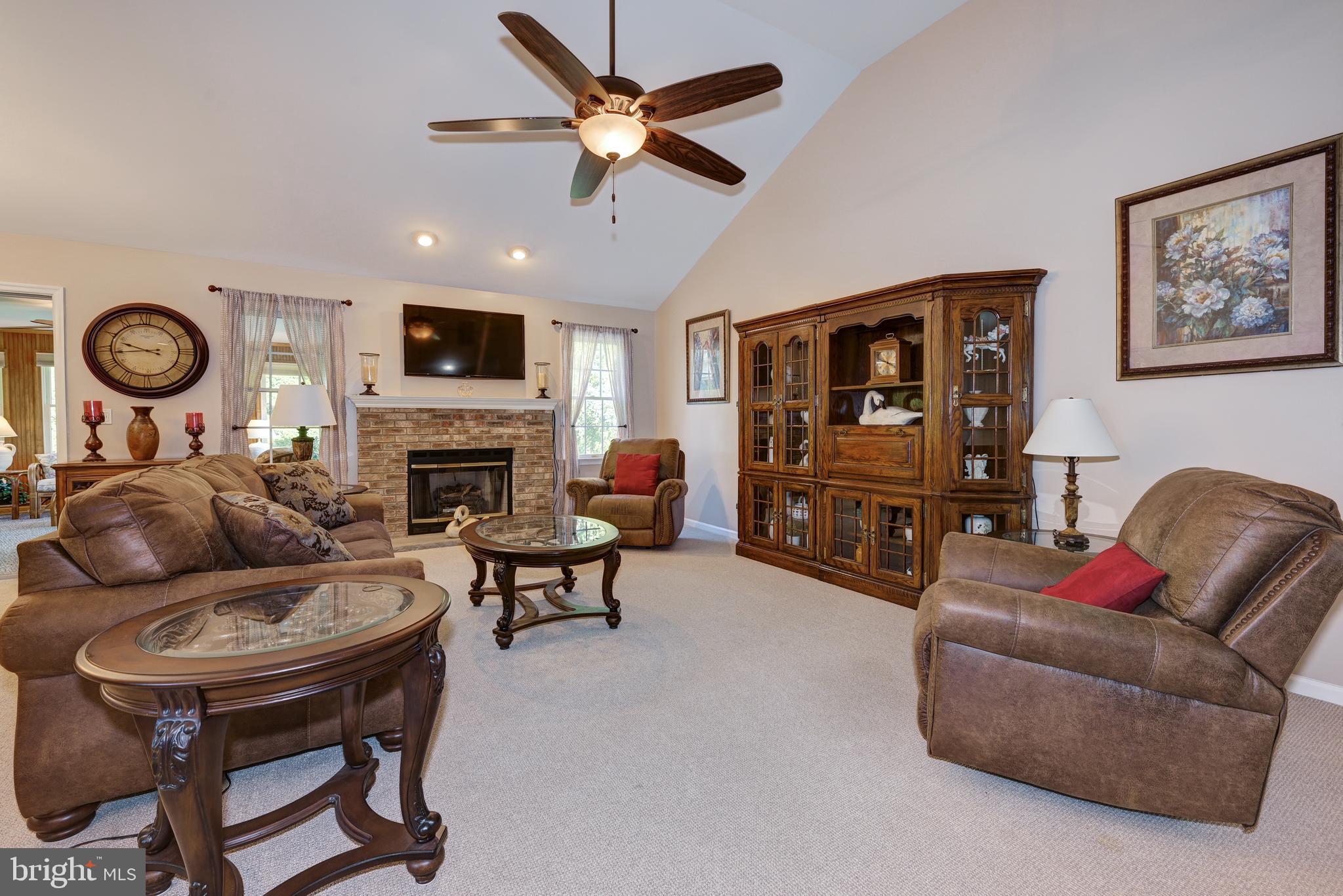 137 Skipper Road Manahawkin, NJ 08050 - Photo 6 of 33 a living room with furniture and a fireplace