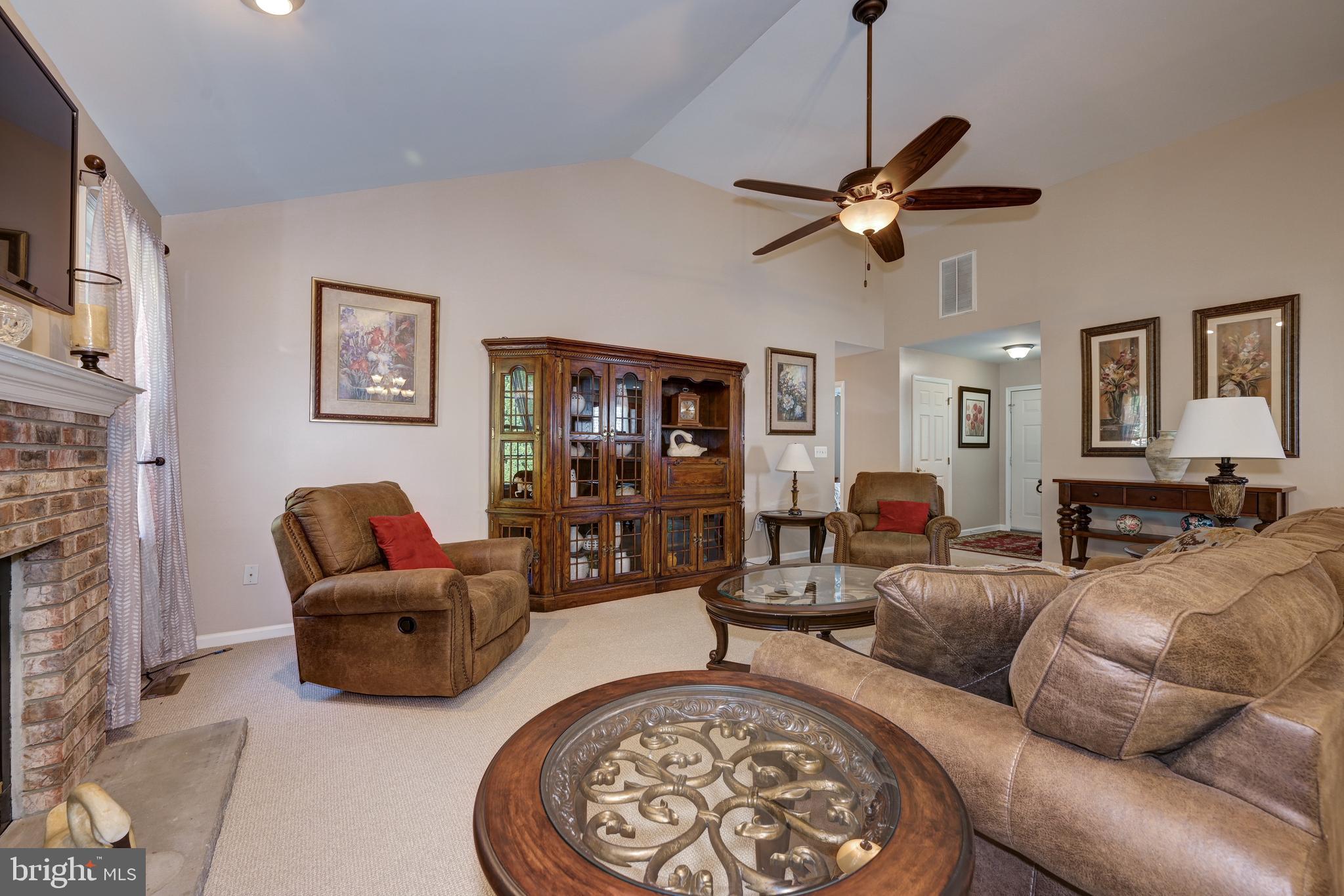 137 Skipper Road Manahawkin, NJ 08050 - Photo 7 of 33 a living room with furniture a fireplace and a flat screen tv