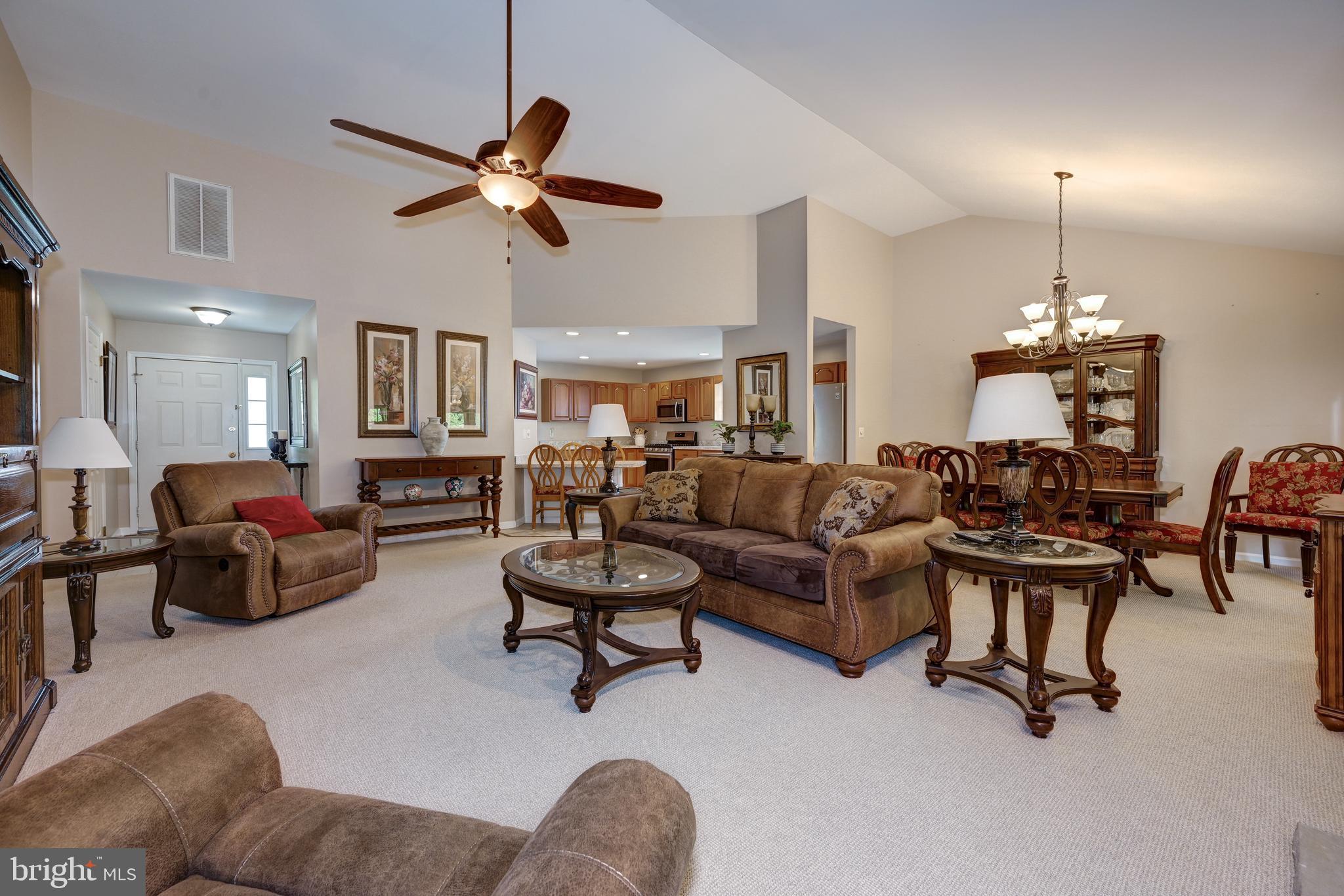 137 Skipper Road Manahawkin, NJ 08050 - Photo 8 of 33 a living room with furniture and a chandelier