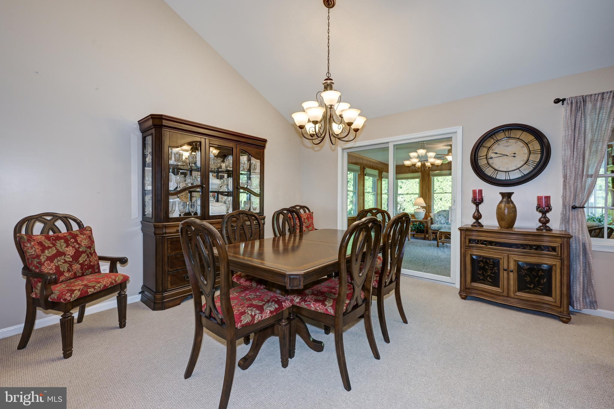 137 Skipper Road Manahawkin, NJ 08050 - Photo 10 of 33 a dining room with furniture a chandelier and a rug