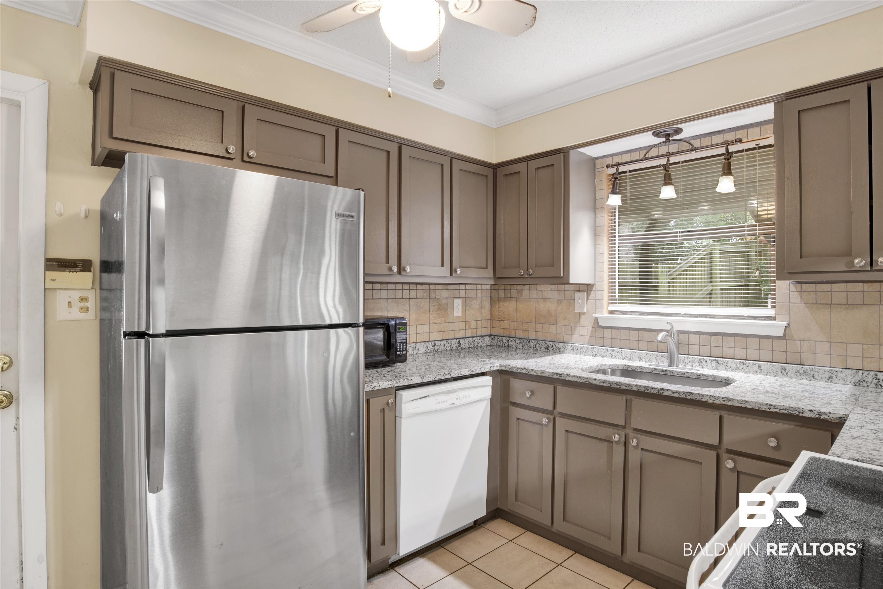 3560 Creekway Road Mobile, AL 36619 - Photo 6 of 24 Kitchen featuring decorative backsplash, dishwasher, ceiling fan, sink, and stainless steel fridge