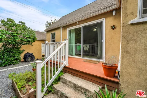 a view of two chairs in the balcony