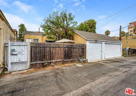 a view of a house with wooden fence