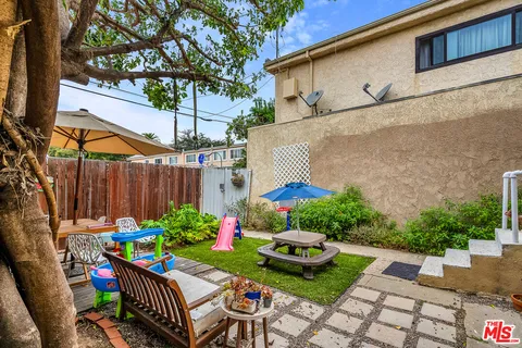 a view of a chairs and table in backyard
