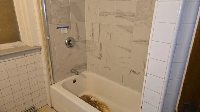 a bathroom with a tub and shower